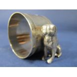 Novelty silver plated napkin ring, the circular ring flanked by a seated hound, 6 cm long