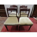 A set of four regency mahogany dining chairs with rope twist splats, upholstered seats and raised on