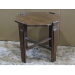 An Art Deco style oak occasional table of octagonal form raised on tapered and moulded supports