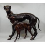 Bronze figure of a standing greyhound and a further smaller example, 50 cm high