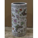 An oriental ceramic umbrella stand of cylindrical form with exotic butterfly and floral detail, 23