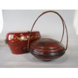 Oriental lacquered twin handled box of ovoid form with gilt decoration of cranes and foliage, 40cm