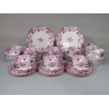 A 19th century tea service with pink lustre floral decoration and painted number to base 4433