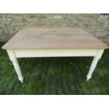A Victorian pine scrub top kitchen table of rectangular form with boarded top raised on ring
