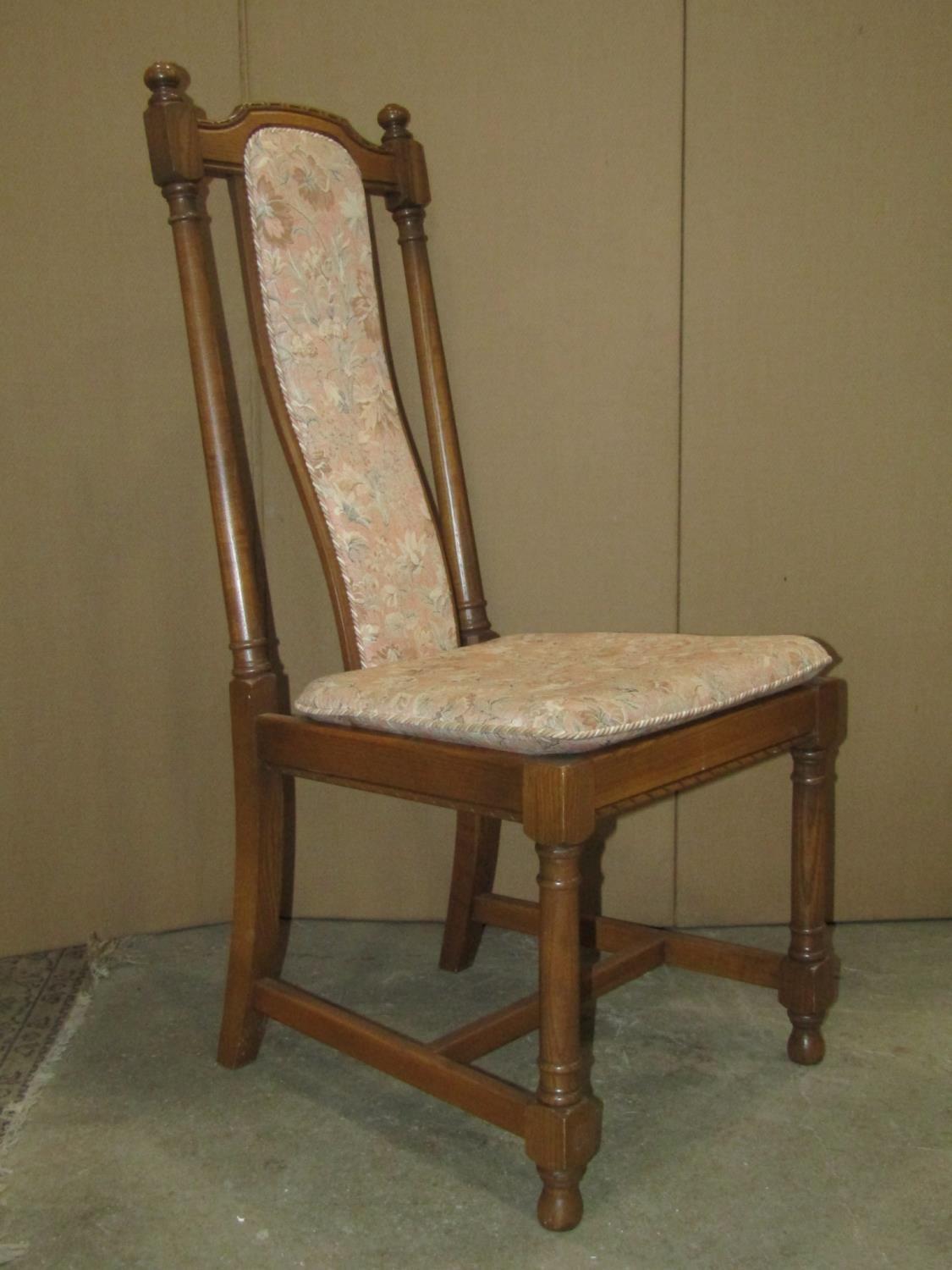 A set of four Ercol medium elm high back dining chairs with upholstered shaped splats over slatted