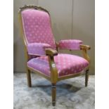 A 19th century reclining open armchair, with pink ground repeating patterned upholstered seat,