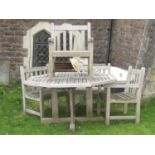 A Gloster weathered teak garden table of octagonal form with segmented slatted top and x framed base