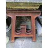 A pair of heavy industrial cast iron table/machine supports of tapered form, 63 cm wide x 73 cm in