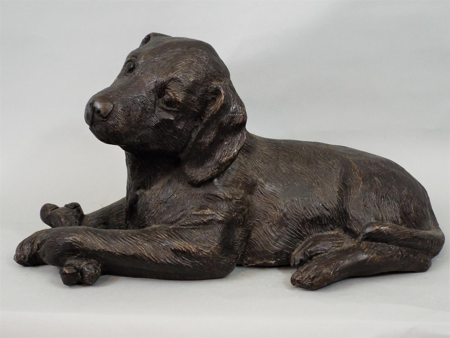 A bronze model of a puppy holding a bone, 20cm approx