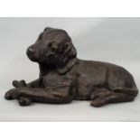 A bronze model of a puppy holding a bone, 20cm approx