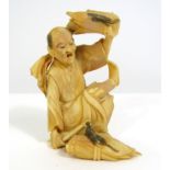 Meiji Period - Ivory Okimono of a seated man with bundles of rice plants greatly surprised by two