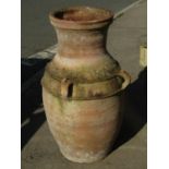 A weathered Mediterranean terracotta olive type jar with drawn neck and moulded handles (AF), 78