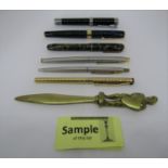 A collection of English coinage, a mid-20th century brass letter knife with Lancelot finial,