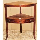 An early 19th century mahogany two tier bow fronted corner table/washstand raised on square cut
