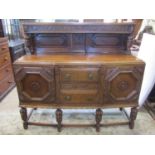 A good quality Jacobean revival oak sideboard with geometric mouldings and repeating grape and