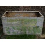 A reclaimed heavy gauge galvanised steel water tank of rectangular form with riveted seams and small