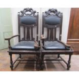 A pair of substantial late 19th century oak elbow chairs with carved and pierced framework and