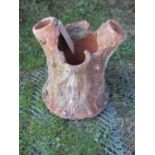 A small naturalistic novelty terracotta planter in the form of a tree stump, 33cm high