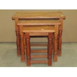 A nest of three good quality oak graduated occasional tables in the Old English style, the