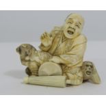 Meiji Period - Ivory Okimono of a seated man accompanied by a dog and a monkey