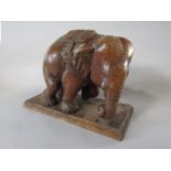 An Indian soft wood carving of a standing elephant, 26 cm high