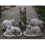 A contemporary composition stone garden ornament in the form of a seated fox and cubs, together with
