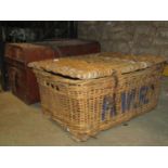 A vintage wicker laundry basket/hamper together with a Victorian domed top tin trunk with leather