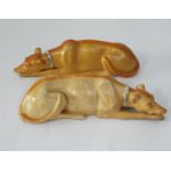 A pair of recumbent greyhounds, with gilded collars, 20cm long