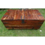 An unusual Indian hardwood chest with segmented hinged lid enclosing small drawers and secret