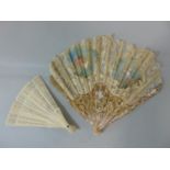 A lace leaf fan with mother of pearl guards. lace leaf with painted sections depicting a fairy and a