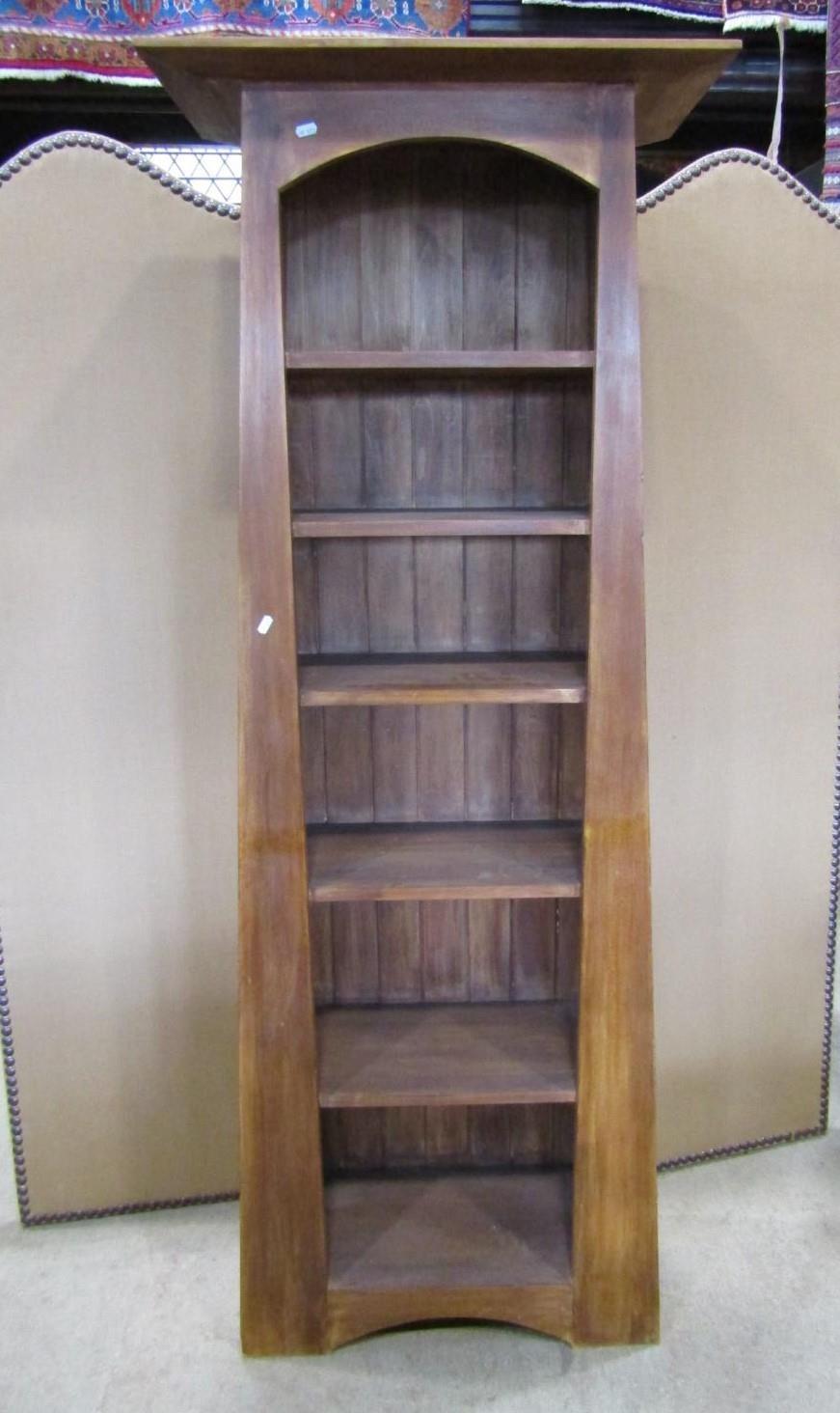 A contemporary Arts & Crafts style hardwood freestanding open bookcase of tapered form with fixed