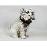 A ceramic figure of a terrier with glass eyes with attached vintage leather collar, 30 cm in height