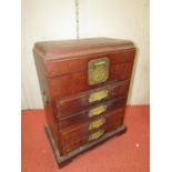 Chinese hardwood cabinet with rising lid over four frieze drawers with brass plate handles and