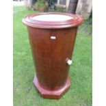 A Victorian mahogany pot cupboard of cylindrical form with inset marble top raised on an octagonal