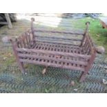 A cast iron fire basket of rectangular form with rope twist bars and toadstool finials, 60 cm x 50