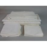 Collection of white table linen including napkins and white damask table cloths together with 16