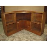 An Art Deco style medium to light oak floorstanding corner bookcase/unit partially enclosed by a