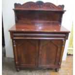A small regency mahogany chiffonier, the base enclosed by a pair of arched and panelled doors and