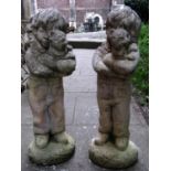A matched pair of contemporary partially weathered composition stone garden ornaments in the form of