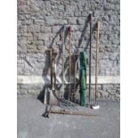 A small collection of wooden long handled gardening tools, together with a vintage mountaineering