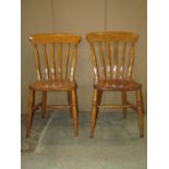 A set of eight Windsor elm and beechwood lathe back kitchen chairs raised on turned supports and