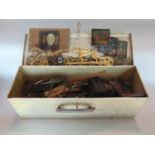 A tin trunk containing a mixture of interesting items mainly magic lanterns, light, horses brasses