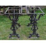 A pair of cast iron pub table bases of rectangular form raised on decorative scrolling acanthus