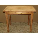 A small vintage stripped pine kitchen table of rectangular form with rounded corners over an end