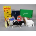 A boxed Shetland cow, a boxed Royal Doulton group of a polar bear and cub - Dedication HN4173, two