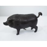 A cast iron butchers shop counter bell in the form of a fat pig, the bell operated by either