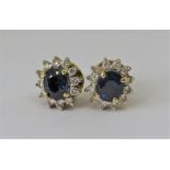 Pair of 18ct sapphire and diamond oval cluster stud earrings, 5g total (2)