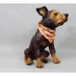 Ceramic figure of a seated terrier with black and tan finish wearing a neckerchief, signed