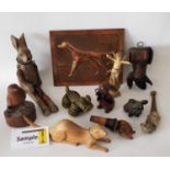 A box containing a miscellaneous collection of carved timber dogs and other animals, a dog made