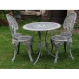A green painted cast aluminium garden terrace table of circular form with decorative pierced top and